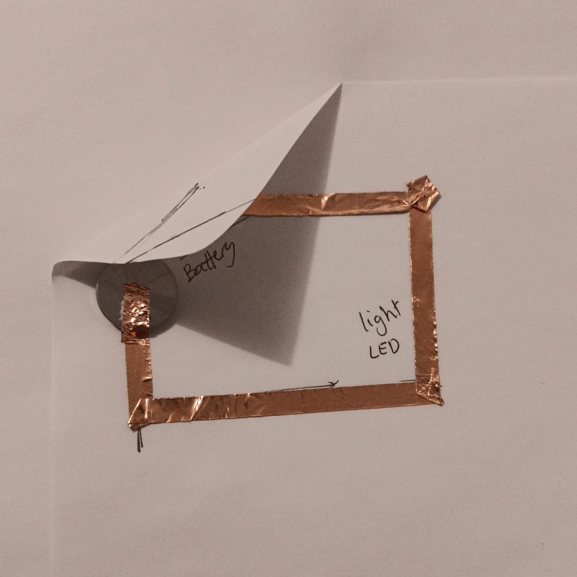 Here I add the copper tape and battery, but it won't work without a switch or light.