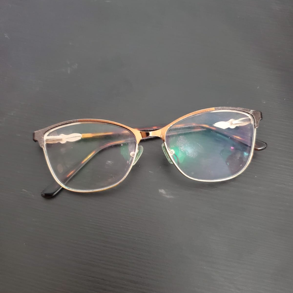 A pair of glasses that afford lifting, adjusting, and repositioning on the face.