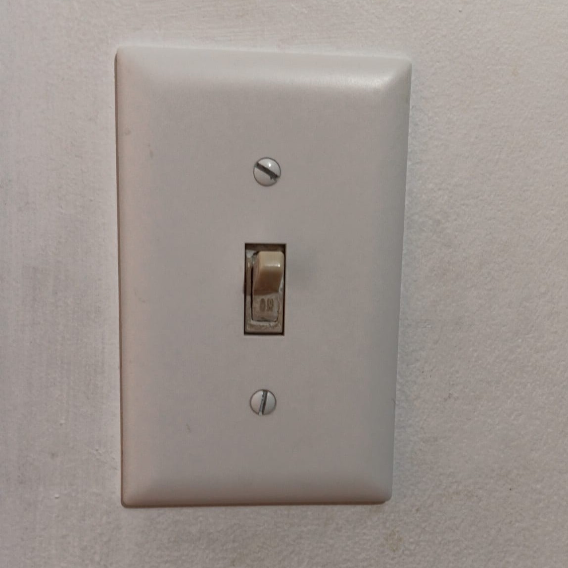 A wall-mounted light switch that suggests flipping up or down to control light.