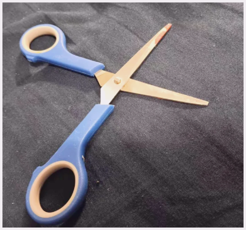 Opened blue scissors.