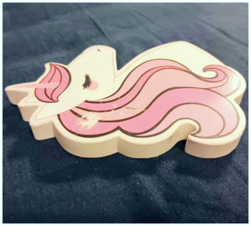 A Unicorn eraser, the photo was taken at an angle to show the thickness of the eraser.